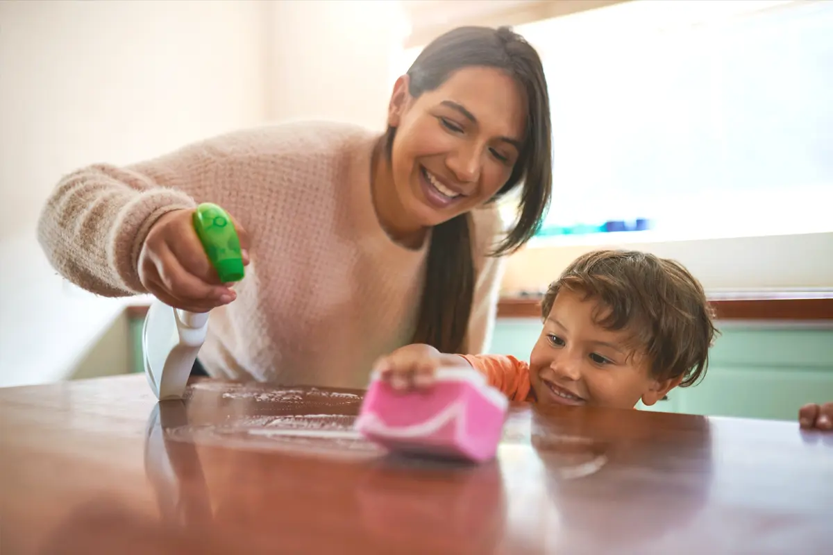 teacher child cleaning table