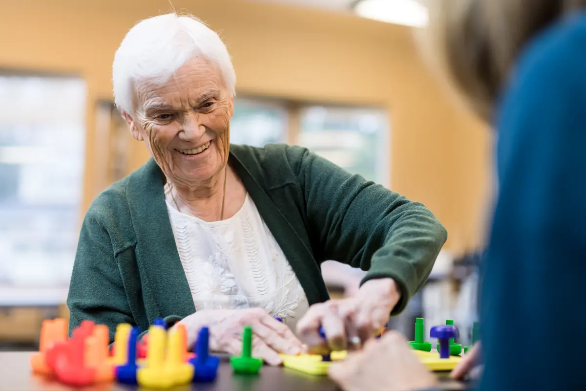 senior citizen doing occupational therapy puzzles