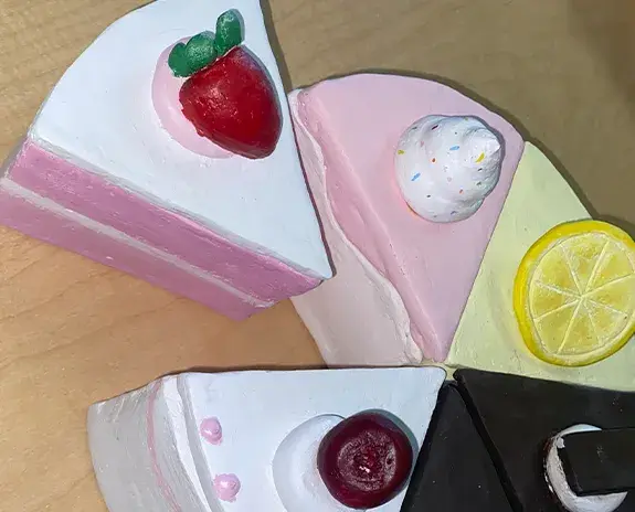 Clay sculpture of different slices of cake.