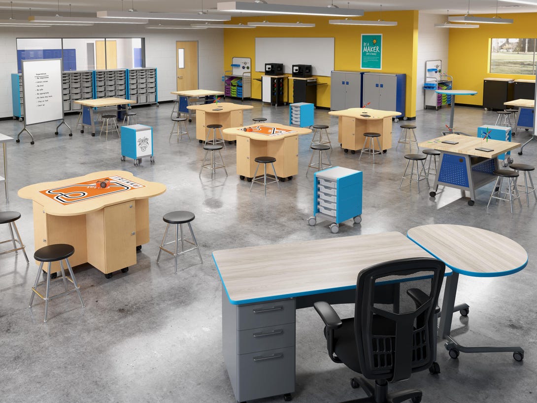 Contemporary classroom makerspace with wood workbenches featuring blue drawer units, round stools, collaborative tables, yellow accent wall, and organized storage cabinets creating flexible learning stations
