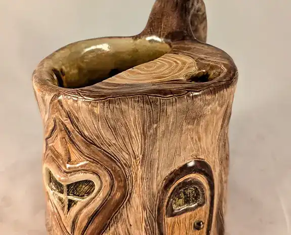 Sculpted mug that resembles a piece of wood.