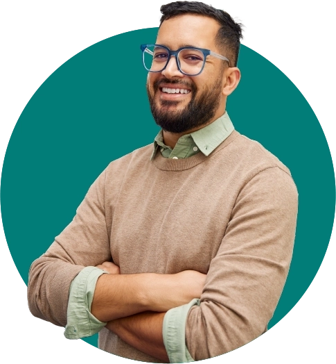 smiling male teacher with his arms crossed