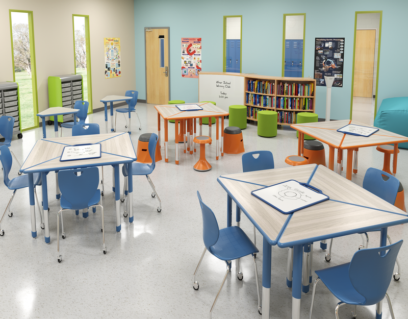 A grey and orange STEM/STEAM learning environment with pod seating, student technology, and several whiteboards.