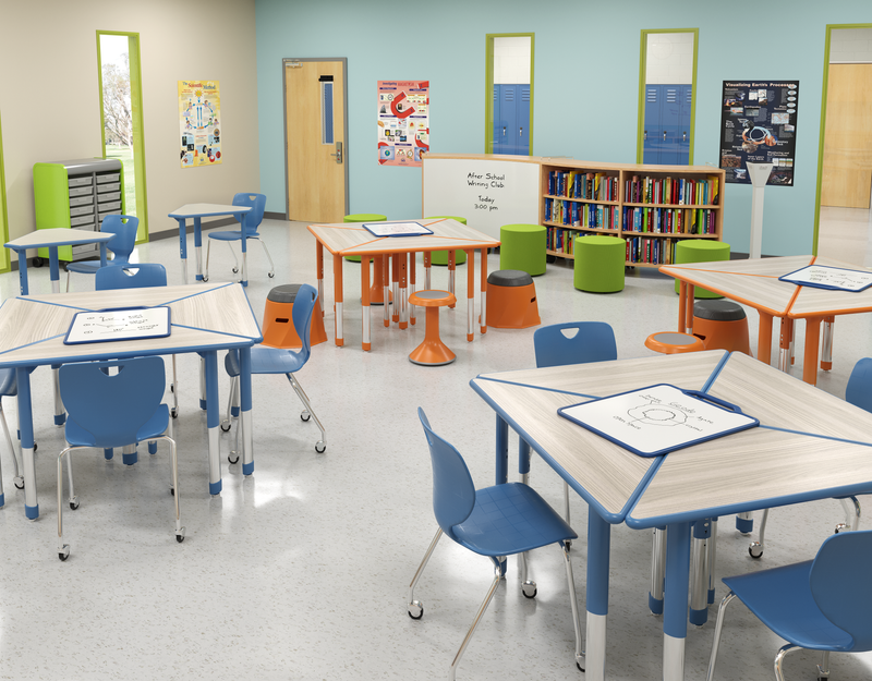 A grey and orange STEM/STEAM learning environment with pod seating, student technology, and several whiteboards.