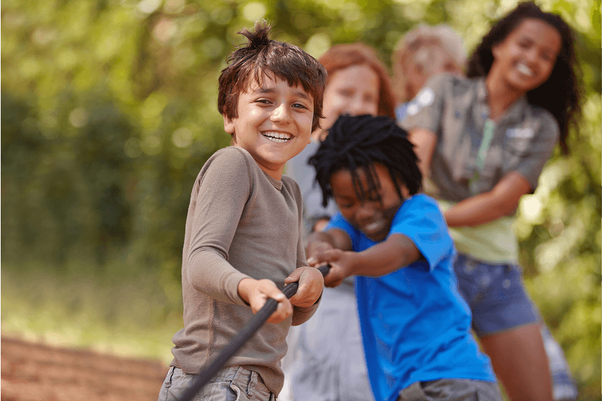 Children playing together outdoors with sports equipment
