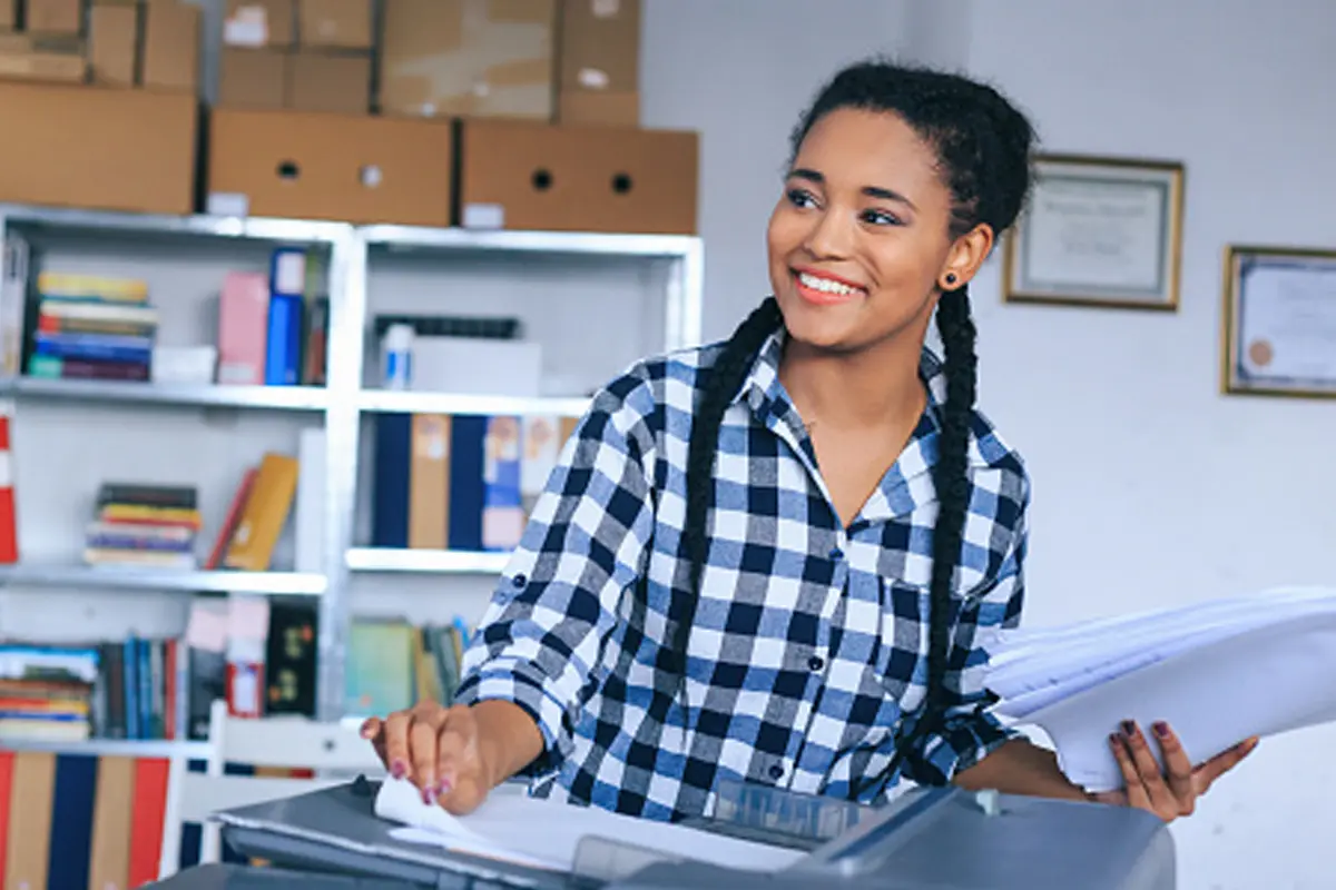 adult working in an office making copies