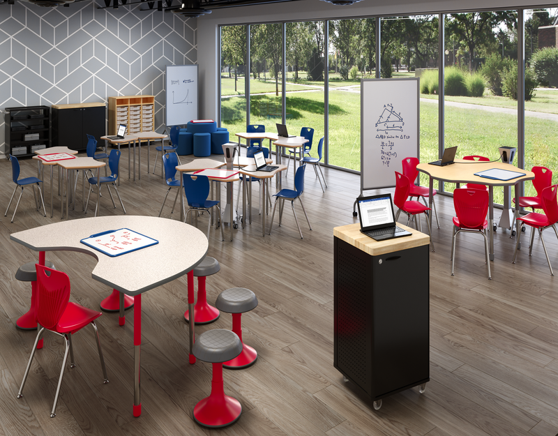 Yellow and orange modern learning environment with pod seating, counter seating, a padded circular bench, and several white boards.