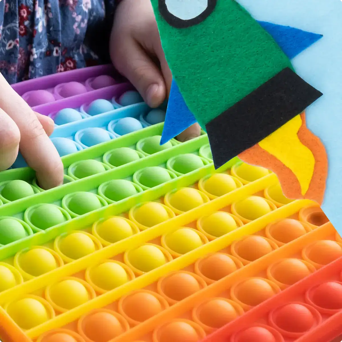 a child's hands pushing pop sensory toy buttons